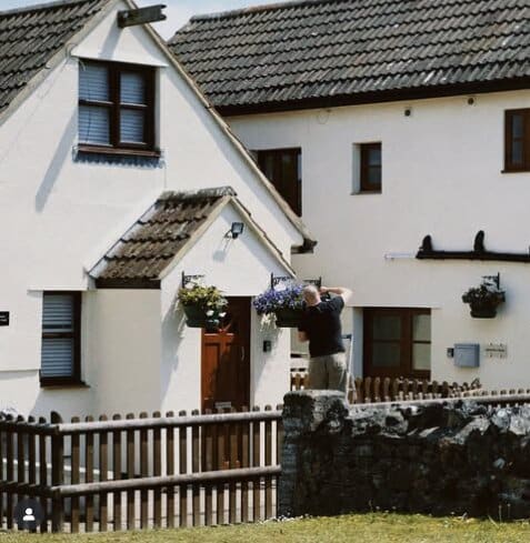 Priory View Cottage with hanging baskets at Norton Court Farm, Kewstoke
